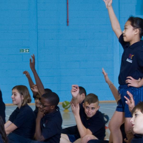 Children reaching into the sky