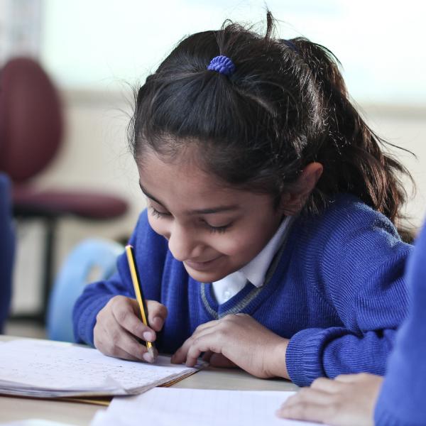 Student writing on paper