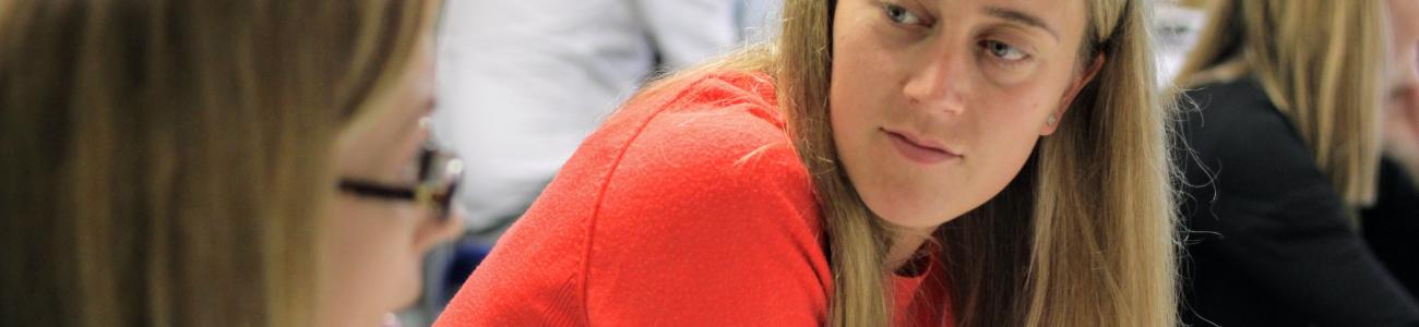 Lady in orange top listening